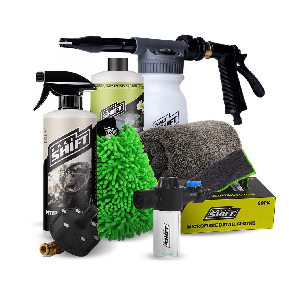 Collection of car care products including bottles, a spray gun, and cloths on a white background.