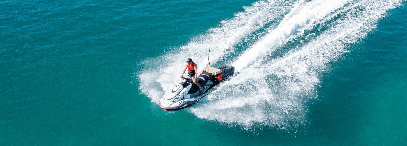 Person on a speedboat in clear blue water