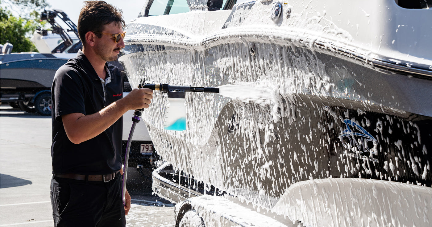 Boat covered in thick foam wash, breaking down salt for a deep clean.