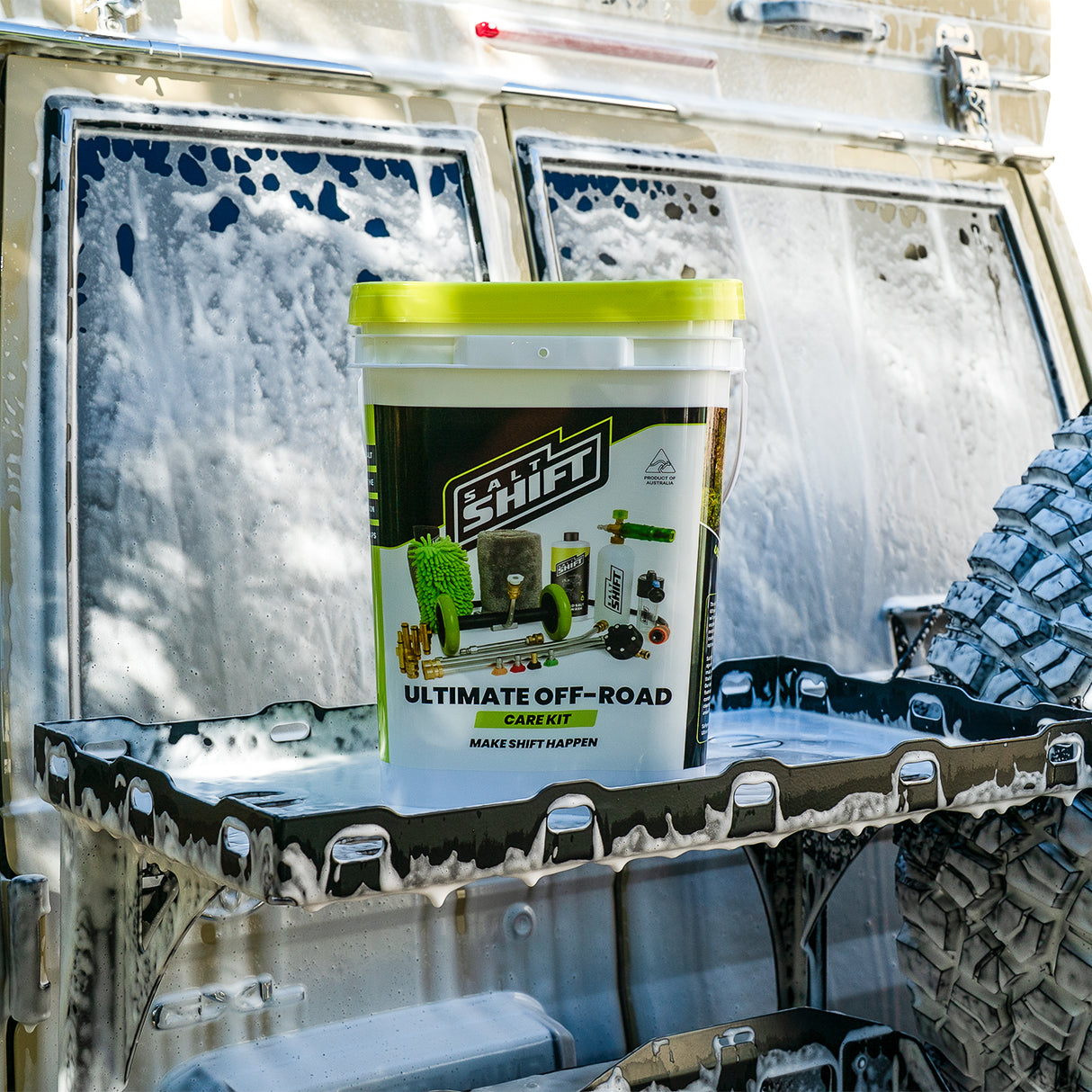 Container labeled 'SHIFT' on a vehicle's cargo area with a tire visible.