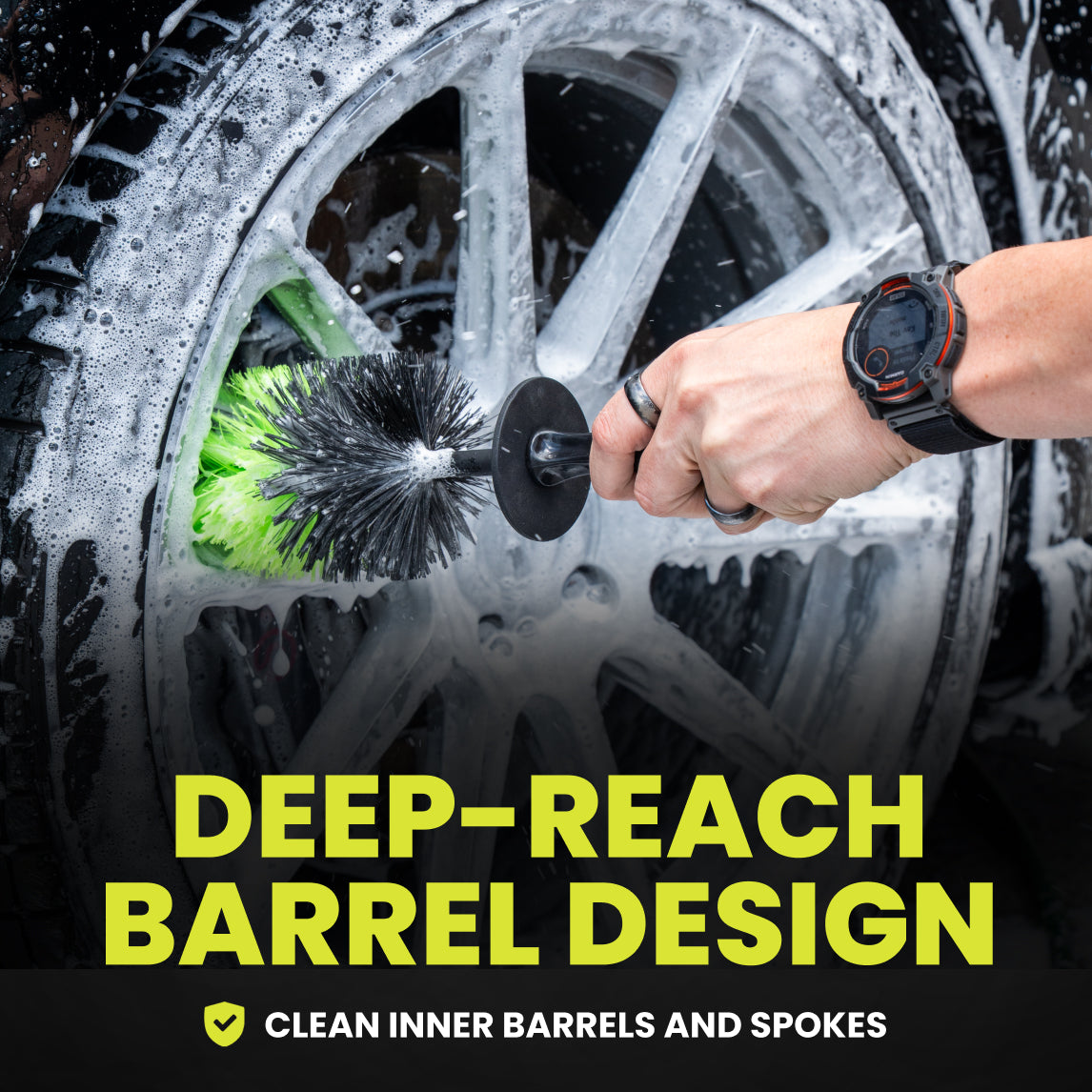Person cleaning a car wheel with a deep-reaching brush, emphasizing the 'Deep-Reach Barrel Design'.