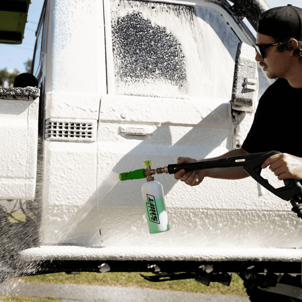 4WD ute covered in thick foam wash, breaking down dirt and grime for a deep clean.