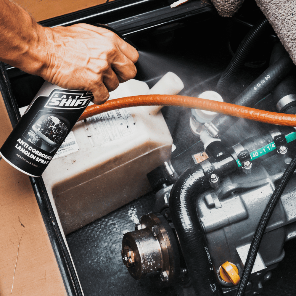 Applying Salt Shift Anti-Corrosion Lanolin Spray to protect engine components from rust, moisture, and wear.