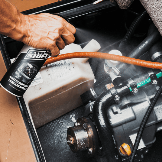 Applying Salt Shift Anti-Corrosion Lanolin Spray to protect engine components from rust, moisture, and wear.