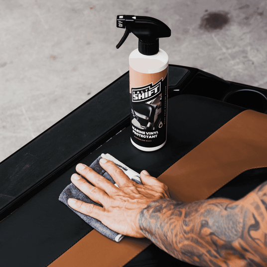 Applying Salt Shift Marine Vinyl Protectant to a microfiber cloth for deep cleaning and UV protection of boat and car interiors.