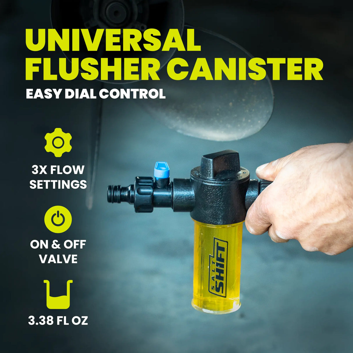 Yellow and black universal flusher canister with hand holding it, on a dark background.