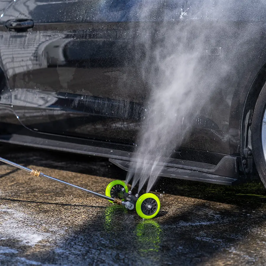 High-pressure washer cleaning a car with water spraying out