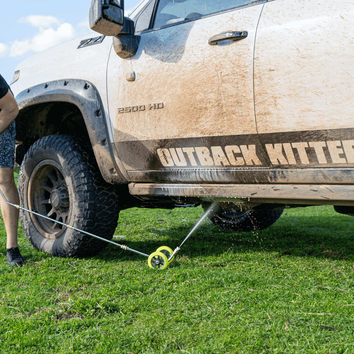 High-pressure underbody wash cleaning a 4x4 vehicle, removing dirt and grime for off-road maintenance and protection.