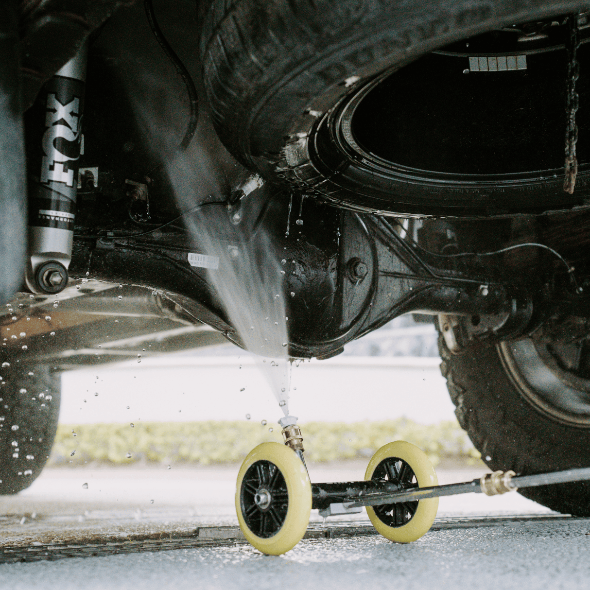 Salt Shift underbody washer cleaning a vehicle’s chassis, removing dirt and grime with high-pressure water spray.