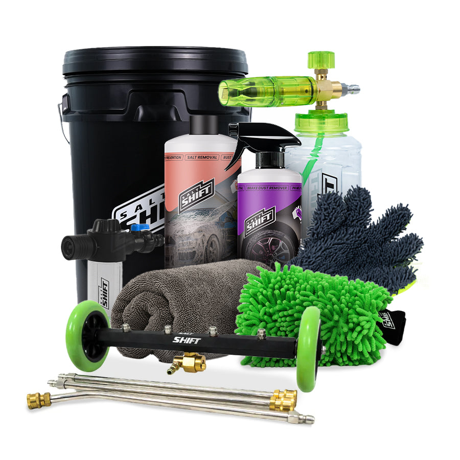 Car cleaning kit with a black bucket, bottles, mitts, and nozzles on a white background.
