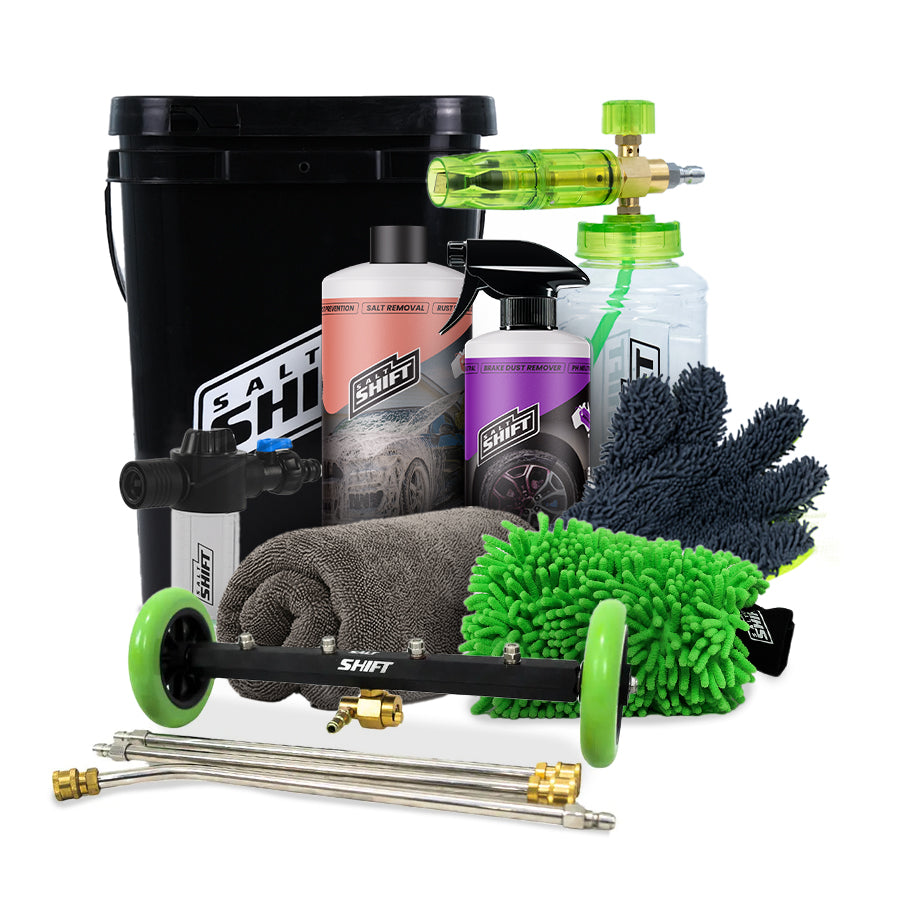 Car cleaning kit with a black bucket, bottles, mitts, and nozzles on a white background.