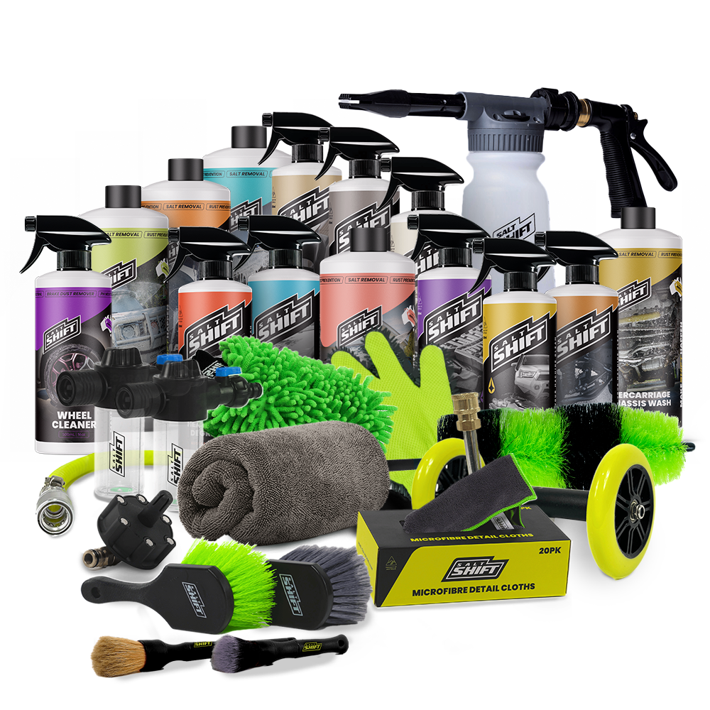 A product bundle of car wash and detailing supplies from Shift Brand, including a black t-shirt, multiple bottles of soap and cleaner, a foam cannon, microfiber cloths, brushes, a towel, and branded caps and patches, arranged on a white background.