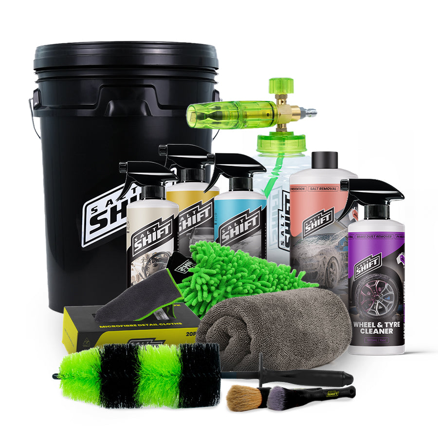 Collection of car care products including bottles, sprays, and cleaning tools on a white background