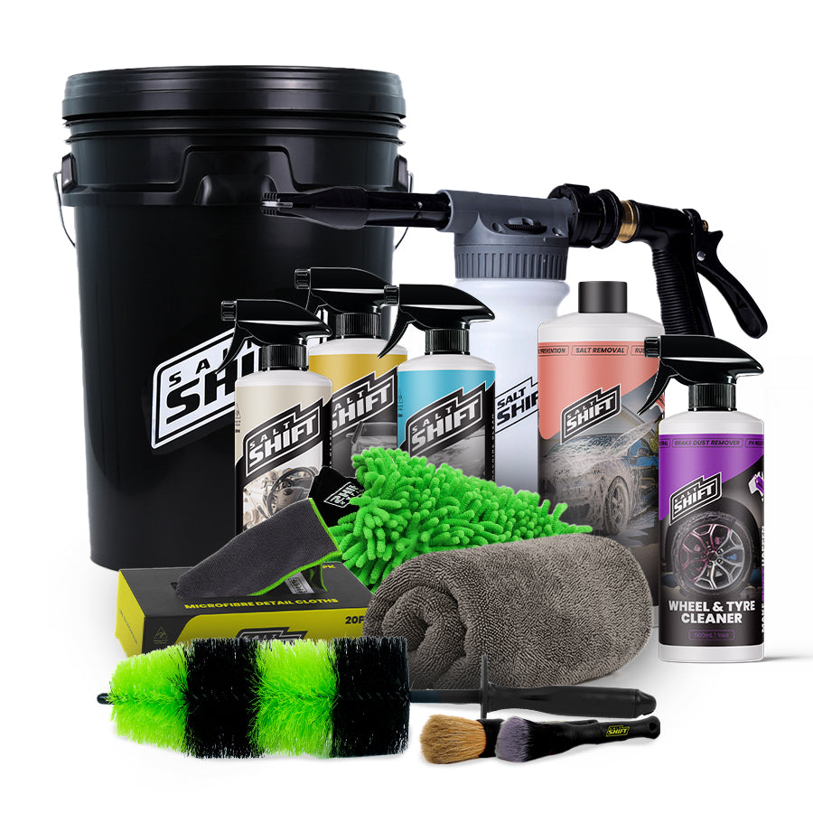 Collection of car care products including bottles, sprays, and cleaning tools on a white background.