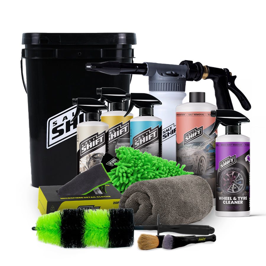 Collection of car care products including bottles, sprays, and cleaning tools on a white background.