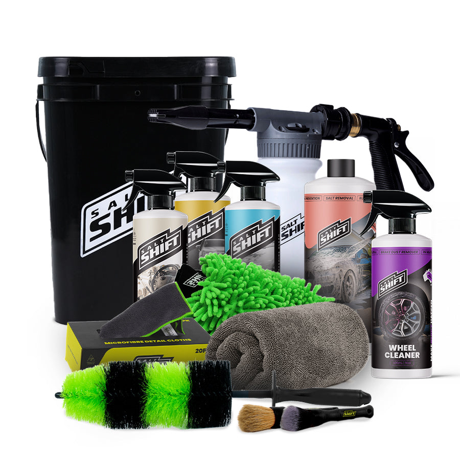Collection of car care products including bottles, sprays, and cleaning tools on a white background.