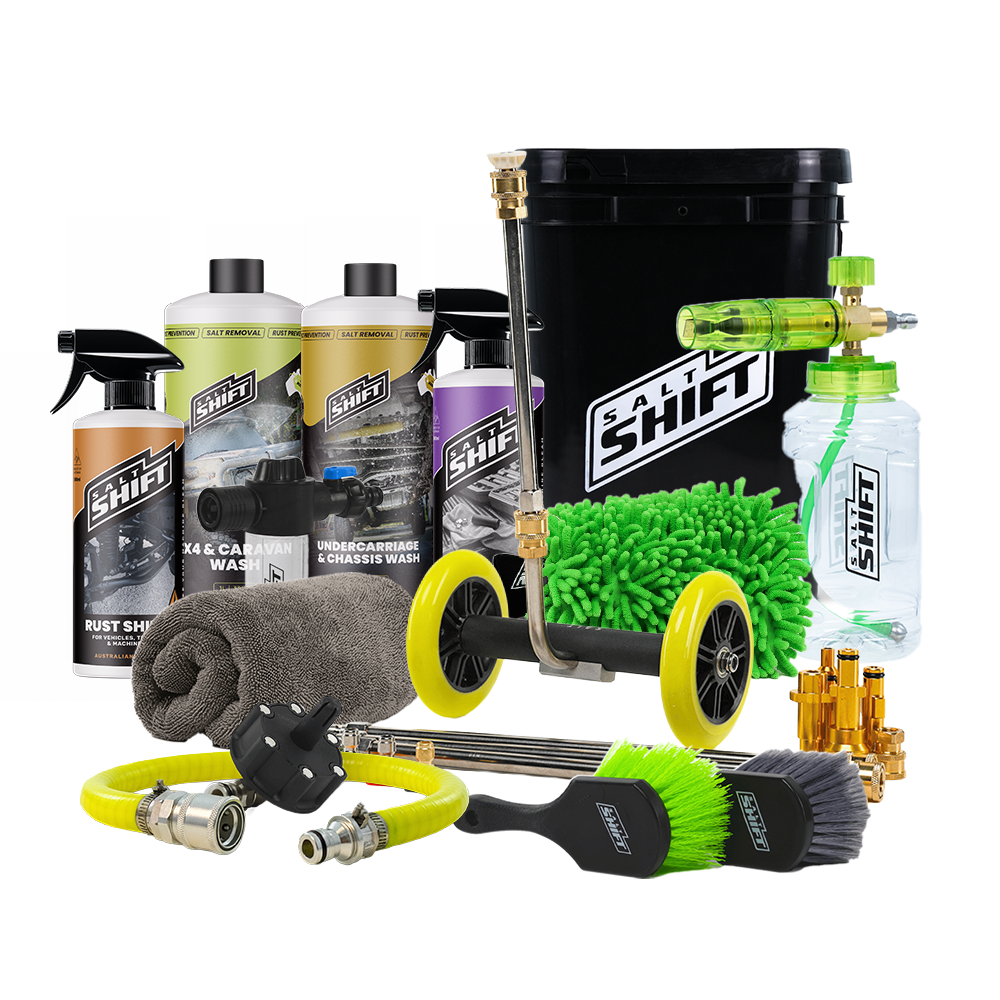 A comprehensive car care and cleaning kit arranged on a white background, featuring multiple bottles of Swift brand cleaners, a green and yellow pressure washer wand with yellow wheels, a green microfiber wash mitt, a gray towel, brass nozzles, and other cleaning accessories.