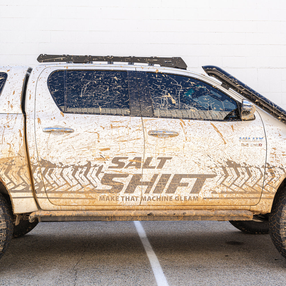 Mud-splattered truck with 'Salt Shift' branding on a white background