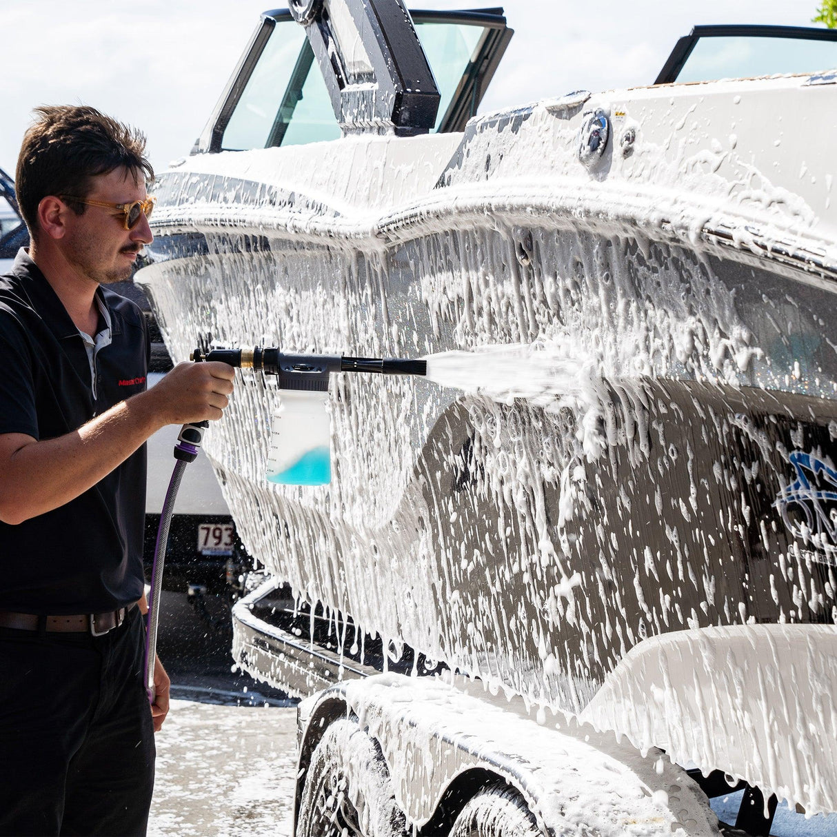 Boat covered in thick foam wash, breaking down salt for a deep clean.