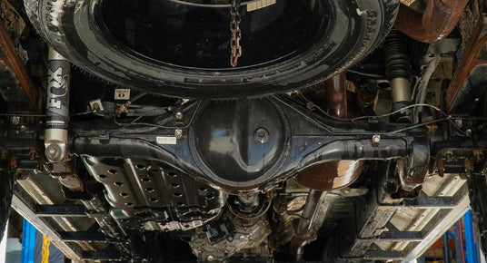 Close-up of a vehicle's undercarriage with suspension components.