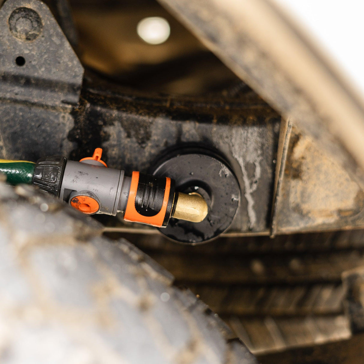 A Salt Shift chassis flusher attached to a 4x4 frame for underbody cleaning.