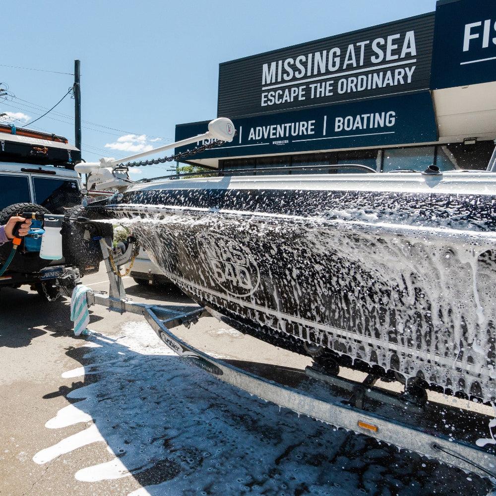Boat covered in light foam wash, breaking down salt for a deep clean.