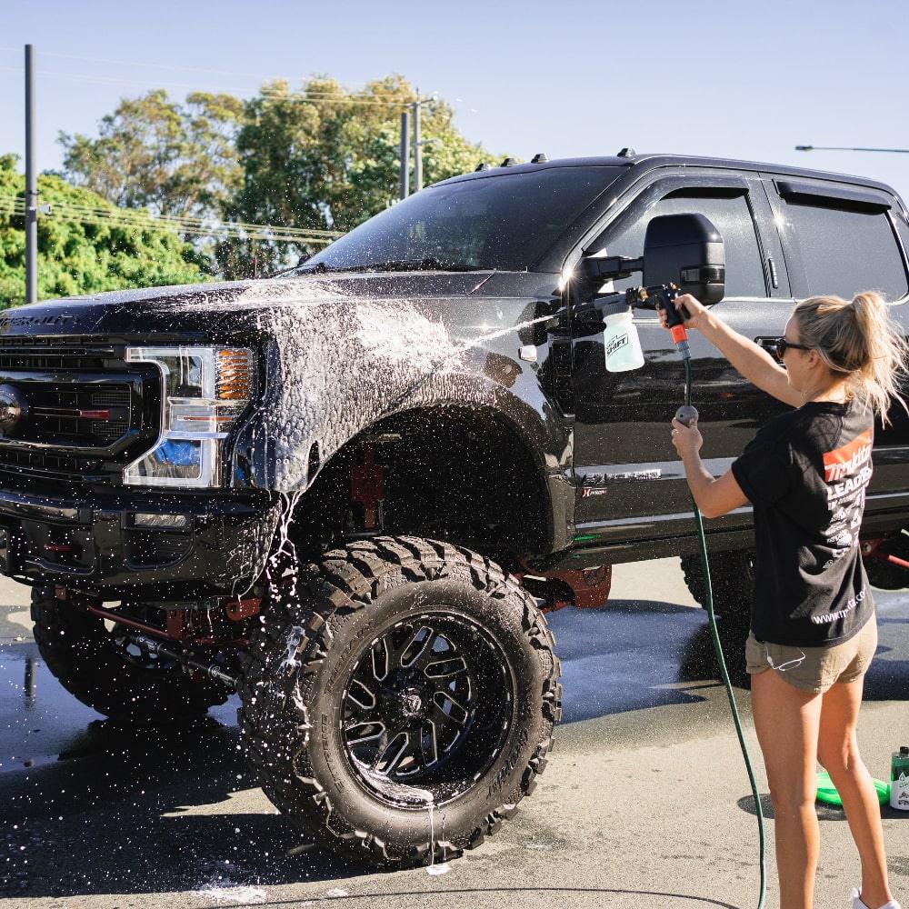 woman cleaning 4x4 with Salt Shift Off-Road Duo Low Pressure