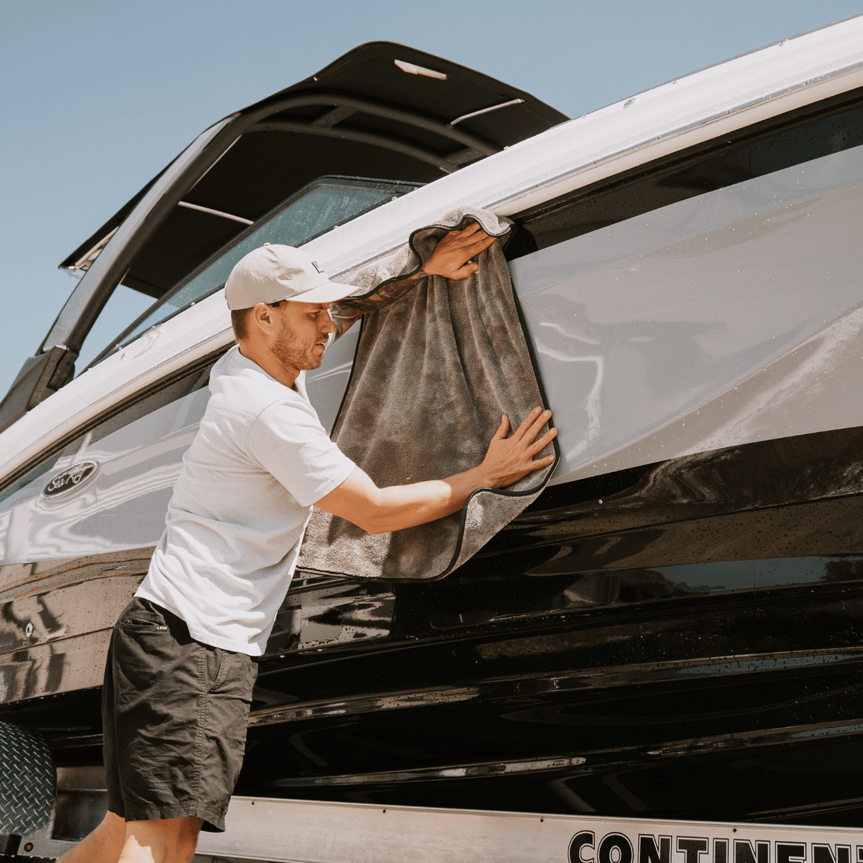 Man drying boat with Salt Shift's dry towel 