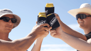 A group of friends cheers with drinks in Salt Shift branded stubby holders.