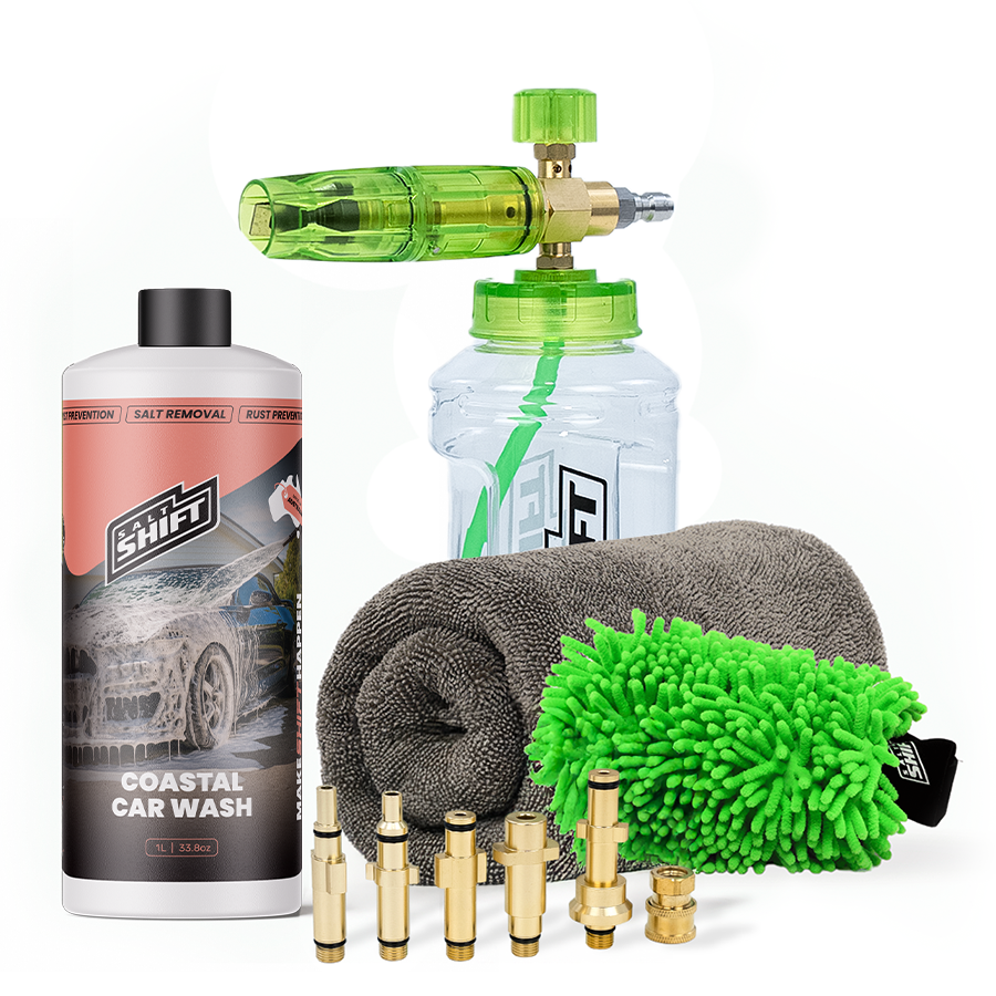 Car cleaning kit with a bottle, sponge, microfiber towel, and nozzles on a white background