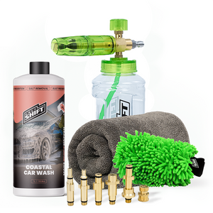 Car cleaning kit with a bottle, sponge, microfiber towel, and nozzles on a white background