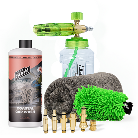 Car cleaning kit with a bottle, sponge, microfiber towel, and nozzles on a white background