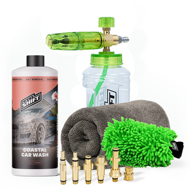 Car cleaning kit with a bottle, sponge, microfiber towel, and nozzles on a white background