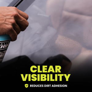 Person cleaning a car window with a spray bottle labeled 'Clear Visability' and text 'Reduces Dirt Adhesion'.