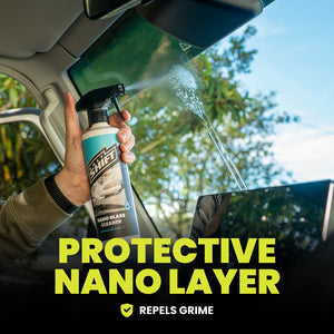 Person applying a protective nano layer to a car window with a spray bottle.