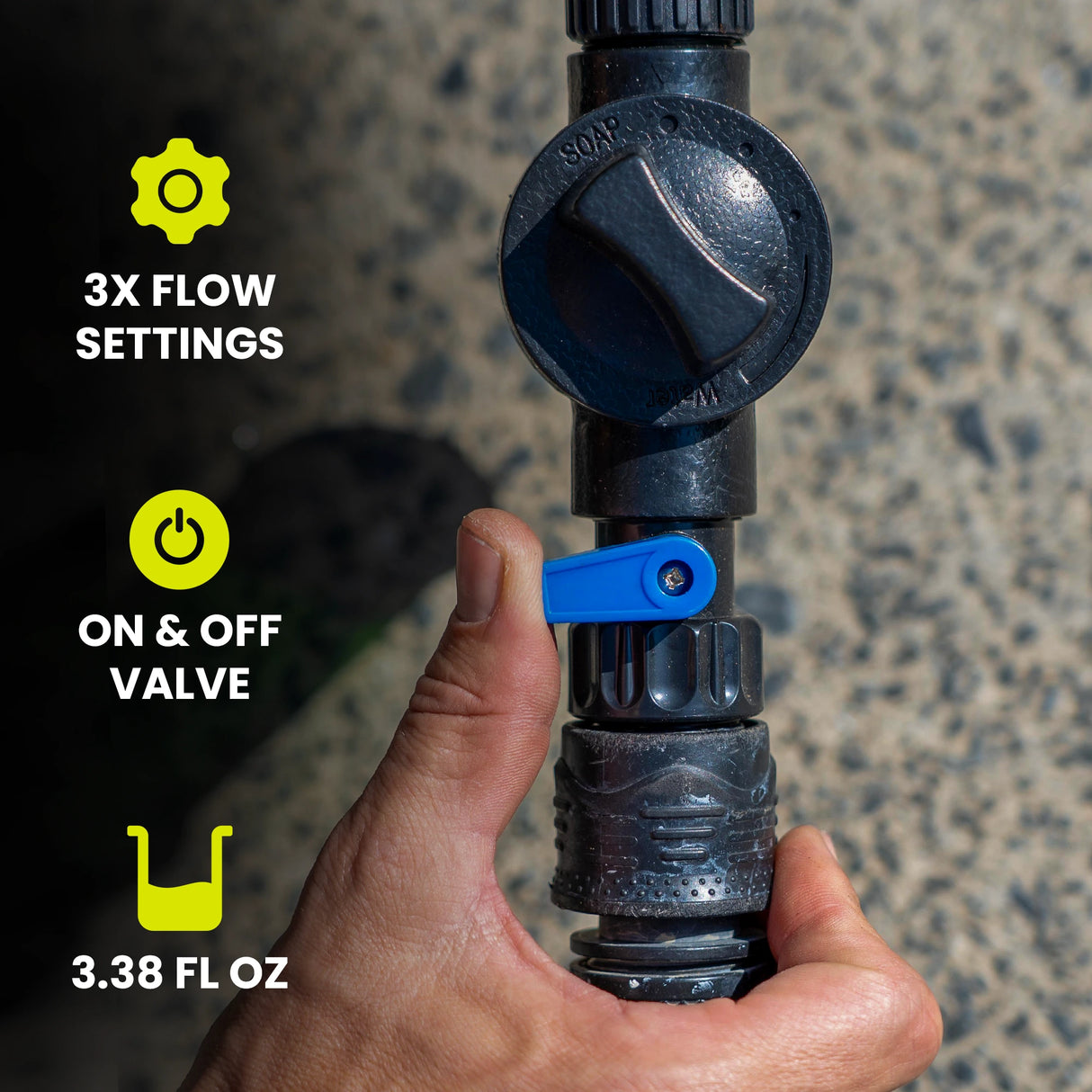 Hand holding a black water valve with flow settings and on/off valve features displayed.