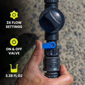 Hand holding a black water valve with flow settings and on/off valve features displayed.