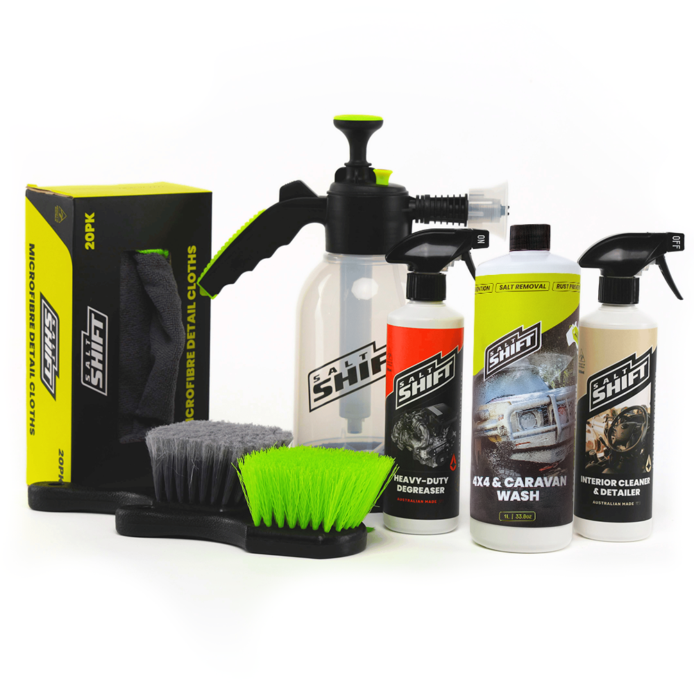 Collection of car care products including bottles, a brush, and a box on a white background