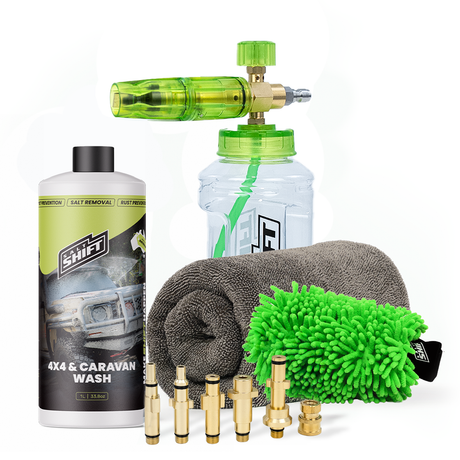 Car wash kit with bottles, nozzles, and cloths on a white background