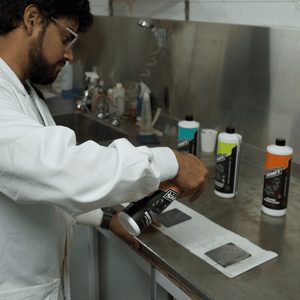 Salt Shift scientist in a laboratory holding Salt Shift cleaning formulas, showcasing product development and testing.