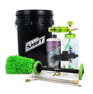 Car cleaning kit with black bucket, bottles, and cleaning tools on a white background