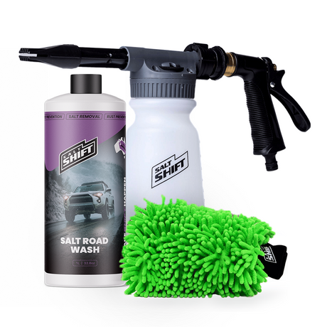 Car wash kit with salt road wash bottle, foam cannon, and microfiber towel on a white background