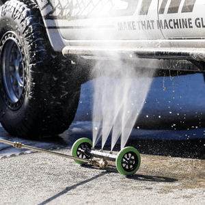 Low-pressure underbody wash cleaning a 4x4 vehicle, removing dirt and grime for off-road maintenance and protection.