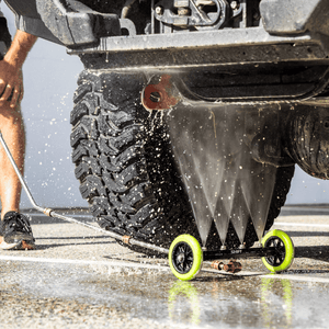 Low-pressure underbody wash cleaning a 4x4 vehicle, removing dirt and grime for off-road maintenance and protection.