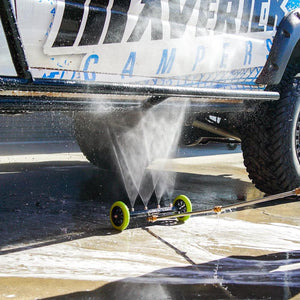 Low-pressure underbody wash cleaning a 4x4 vehicle, removing dirt and grime for off-road maintenance and protection.