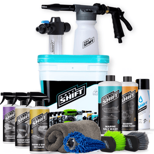 Salt Shift marine cleaning kit featuring a bucket, spray gun, bottles, brushes, microfibre towels, and cleaning accessories.