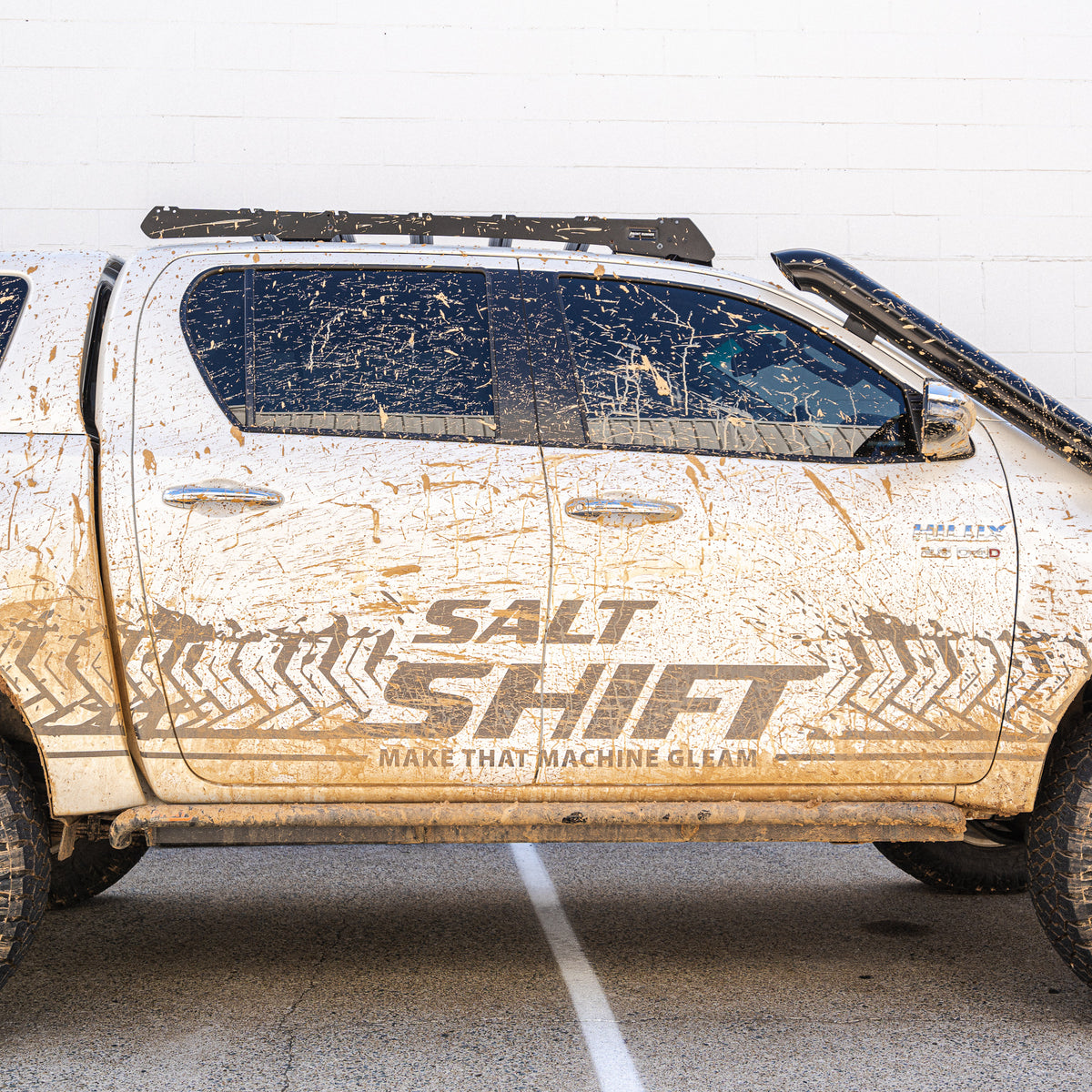 Mud-splattered truck with 'Salt Shift' branding on a white background