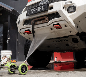 Salt Shift underbody cleaning tool spraying water to remove mud and grime from a 4WD chassis.