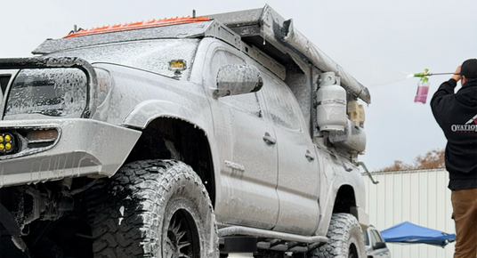 Large off-road vehicle with a person taking a photo in the background