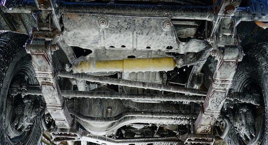 Close-up view of a vehicle's undercarriage with visible suspension components.